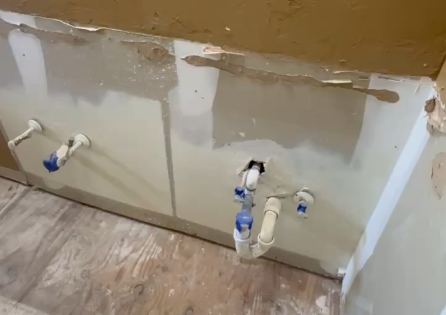 Supply lines roughed in a bathroom wall